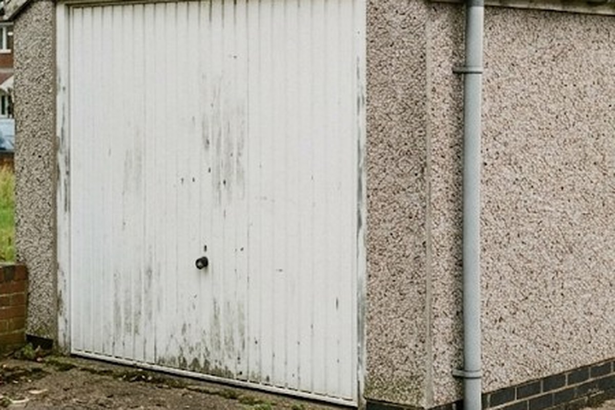 Old garage with a weathered asbestos cement roof edge